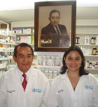 Victor C. Ortiz and Dr. Alejandra Ortiz in pharmacist lab coats