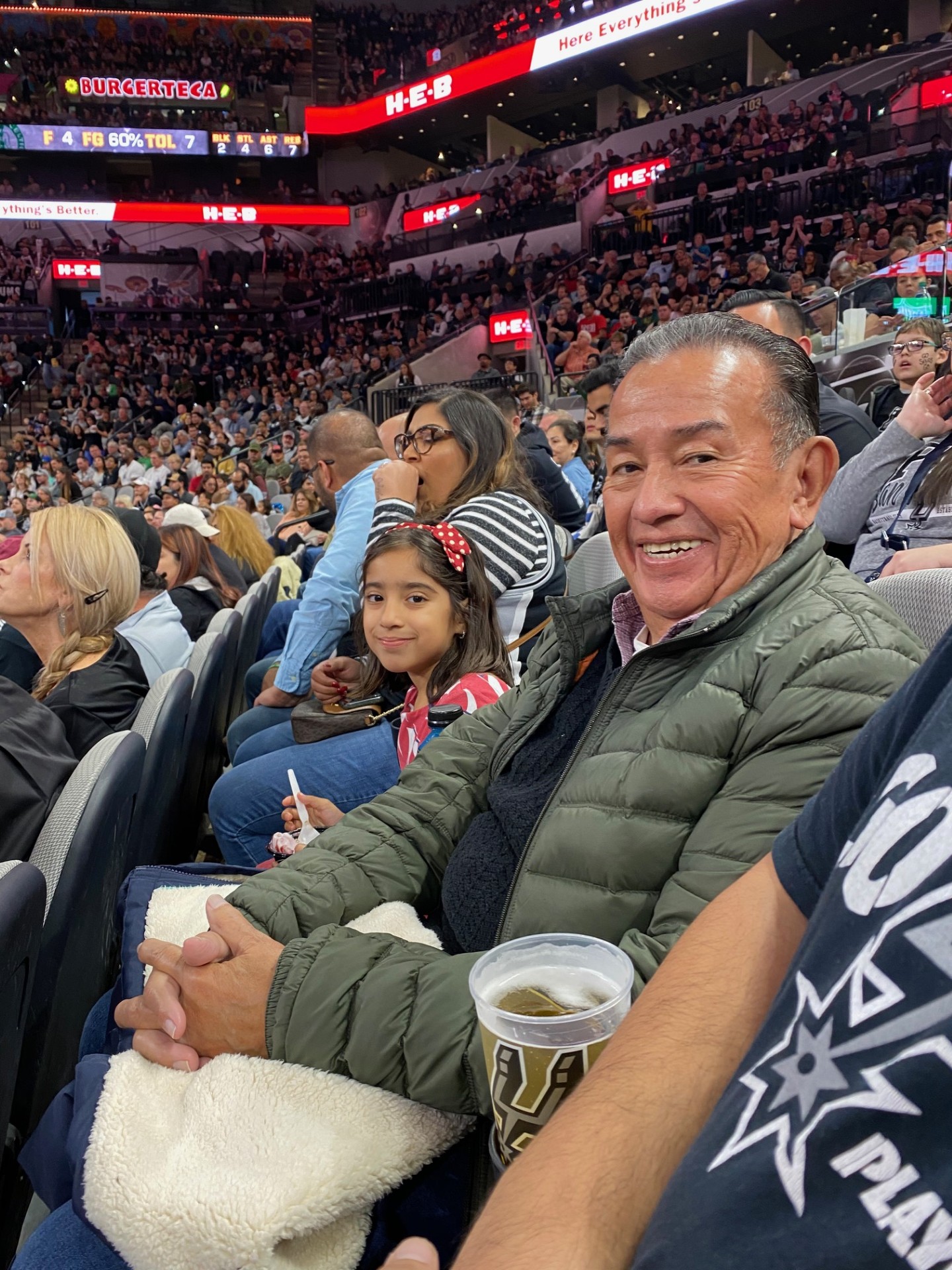 Victor C. Ortiz with his granddaughter Olivia at a San Antonio Spurs game
